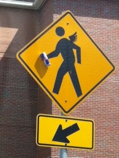 Crosswalk sign with energy drink.